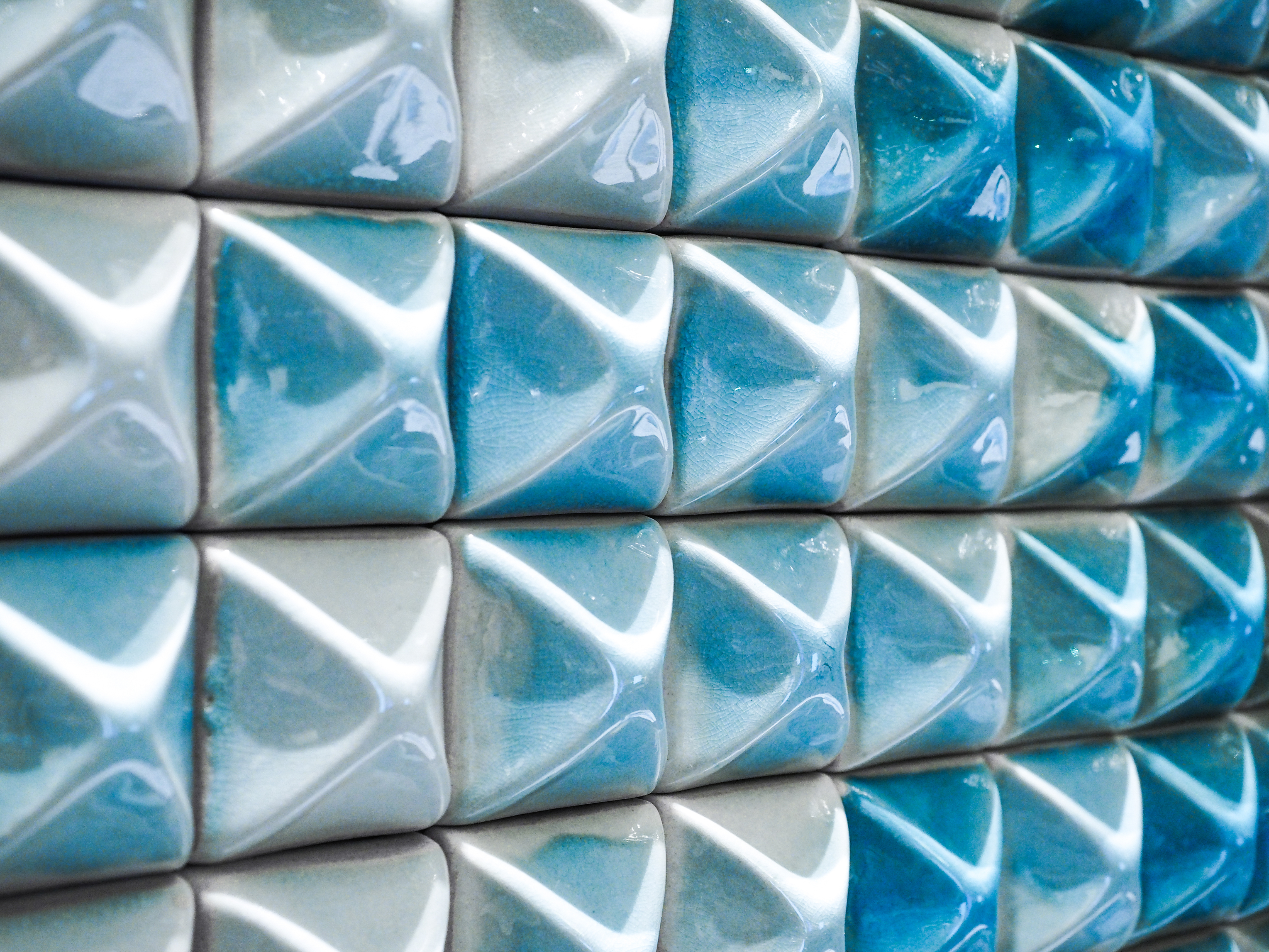 Porcelain ingots are grouped following color gradation to represent an authentic lakescape